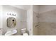 Clean bathroom featuring a vanity, round mirror, toilet, and tiled walk-in shower at 4912 Lightwood Nw Ct, Acworth, GA 30102
