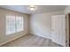 Bedroom with carpeting, neutral walls, and window providing natural light at 4912 Lightwood Nw Ct, Acworth, GA 30102