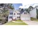 Charming two-story home with a two-car garage, black shutters, and a well-manicured front yard at 4912 Lightwood Nw Ct, Acworth, GA 30102