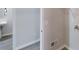 Hallway connecting the laundry room and a full bathroom with a tiled walk-in shower at 4912 Lightwood Nw Ct, Acworth, GA 30102