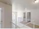 Bright hallway with white banister, light carpeting, and a chandelier fixture at 4912 Lightwood Nw Ct, Acworth, GA 30102