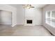 Spacious living room featuring vinyl floors, large windows and a fireplace with white trim at 4912 Lightwood Nw Ct, Acworth, GA 30102