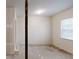 Empty room with white walls, painted concrete floors and a large window with natural light at 4912 Lightwood Nw Ct, Acworth, GA 30102