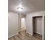 Bedroom featuring neutral walls, a closet with open doors, and wood laminate flooring at 7125 Puckett Sw St, Covington, GA 30014