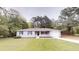 Charming single-story home with gray paint, complemented by a lush green lawn at 7125 Puckett Sw St, Covington, GA 30014