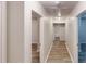 Hallway with wood-look floors, leading to various rooms in the home at 7125 Puckett Sw St, Covington, GA 30014