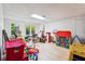 A daylight basement recreation room featuring vinyl floors and a walk-out to the yard at 9545 Kingston Crossing Cir, Alpharetta, GA 30022