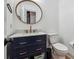 Bathroom with blue vanity and round mirror at 9545 Kingston Crossing Cir, Alpharetta, GA 30022