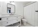 Well-lit bathroom with a white vanity, a modern faucet, and a coordinated white toilet and shower at 9545 Kingston Crossing Cir, Alpharetta, GA 30022