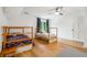 Bright bedroom featuring wooden floors and matching frame bunk beds, perfect for a cozy, shared space at 9545 Kingston Crossing Cir, Alpharetta, GA 30022