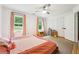 Comfortable bedroom featuring light hardwood floors, natural light, and ample storage space with white closets at 9545 Kingston Crossing Cir, Alpharetta, GA 30022