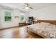 Bright bedroom featuring hardwood floors, neutral walls, and a dedicated desk area perfect for work or study at 9545 Kingston Crossing Cir, Alpharetta, GA 30022