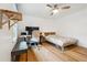 Clean bedroom offers light hardwood floors, a dedicated workspace, and a comfortable bed with a simple design at 9545 Kingston Crossing Cir, Alpharetta, GA 30022