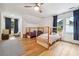Charming bedroom with light hardwood floors, bunk beds, a ceiling fan, and natural light from bright windows at 9545 Kingston Crossing Cir, Alpharetta, GA 30022
