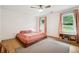Inviting bedroom with a platform bed, hardwood floors, neutral carpet, and a shelving unit by bright windows at 9545 Kingston Crossing Cir, Alpharetta, GA 30022
