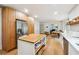 Open-concept kitchen features stainless steel appliances, and a view to the dining area at 9545 Kingston Crossing Cir, Alpharetta, GA 30022