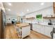 Eat-in kitchen with stainless steel appliances, white cabinets, and hardwood floors at 9545 Kingston Crossing Cir, Alpharetta, GA 30022