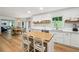 Bright kitchen featuring white cabinets, stainless steel appliances, and access to dining area at 9545 Kingston Crossing Cir, Alpharetta, GA 30022