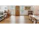 Large room with light hardwood flooring, neutral walls, and two windows with classic, white shutters at 9545 Kingston Crossing Cir, Alpharetta, GA 30022