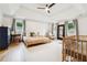 Spacious main bedroom with hardwood floors, vaulted ceiling, ensuite Bedroom, and three bright windows with views at 9545 Kingston Crossing Cir, Alpharetta, GA 30022