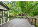 Outdoor wooden deck with railings and views of the backyard landscaping at 11950 Wildwood Springs Dr, Roswell, GA 30075