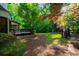 Lush green backyard featuring mature trees and a well-maintained lawn, perfect for outdoor activities at 11950 Wildwood Springs Dr, Roswell, GA 30075