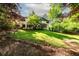 Spacious backyard with a well-manicured lawn and mature trees, providing privacy and shade at 11950 Wildwood Springs Dr, Roswell, GA 30075