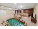 Finished basement with carpet flooring, entertainment center and recreational games at 11950 Wildwood Springs Dr, Roswell, GA 30075