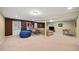 Finished basement with carpet flooring, recreational games and comfortable seating at 11950 Wildwood Springs Dr, Roswell, GA 30075