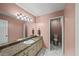 Bathroom featuring a single vanity with granite counters, framed mirror and private toilet at 11950 Wildwood Springs Dr, Roswell, GA 30075