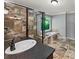 Beautiful bathroom with a large tub with a window overlooking a wooded area at 11950 Wildwood Springs Dr, Roswell, GA 30075