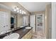 Bathroom featuring a double vanity with granite counters, framed mirrors and updated lighting at 11950 Wildwood Springs Dr, Roswell, GA 30075
