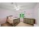 Bedroom decorated with pink walls, butterfly decor, and large windows at 11950 Wildwood Springs Dr, Roswell, GA 30075
