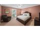 Bedroom features a queen-size bed, sitting chair, carpet flooring, and a window with natural light at 11950 Wildwood Springs Dr, Roswell, GA 30075