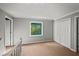 Upstairs bedroom with plush carpeting, closet and natural light at 11950 Wildwood Springs Dr, Roswell, GA 30075
