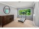 Bonus room showcasing natural light from the large window and includes a treadmill at 11950 Wildwood Springs Dr, Roswell, GA 30075