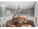 Formal dining room with hardwood floors, gray walls, and elegant chandelier at 11950 Wildwood Springs Dr, Roswell, GA 30075