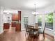 Dining room with wood floors, chandelier, and view into kitchen at 11950 Wildwood Springs Dr, Roswell, GA 30075