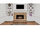 Close-up of stone fireplace and built-in shelving with decorative items at 11950 Wildwood Springs Dr, Roswell, GA 30075