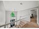 Foyer featuring stairs with white railings, large windows, and a black front door at 11950 Wildwood Springs Dr, Roswell, GA 30075