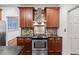 Kitchen featuring wood cabinets, a gas range, and stainless steel appliances at 11950 Wildwood Springs Dr, Roswell, GA 30075