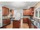 Large kitchen with wood cabinets, stainless steel appliances, and granite countertops at 11950 Wildwood Springs Dr, Roswell, GA 30075