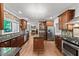 Spacious kitchen with wood cabinets, granite countertops, and stainless steel appliances at 11950 Wildwood Springs Dr, Roswell, GA 30075