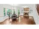 Bright living room with hardwood floors, a stone fireplace, and large windows at 11950 Wildwood Springs Dr, Roswell, GA 30075