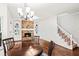 Cozy living room featuring hardwood floors, a stone fireplace, and custom bookshelves at 11950 Wildwood Springs Dr, Roswell, GA 30075