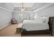 Bright main bedroom with a decorative trey ceiling and a ceiling fan at 11950 Wildwood Springs Dr, Roswell, GA 30075