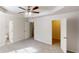 Large primary bedroom featuring ceiling fan and multiple doors at 4954 River Overlook Way, Lithonia, GA 30038