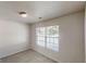 Bright bedroom featuring a window with blinds and neutral carpet at 4954 River Overlook Way, Lithonia, GA 30038