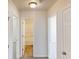 Hallway with three doors leading to bedrooms and bathrooms at 4954 River Overlook Way, Lithonia, GA 30038