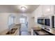 Open kitchen with granite countertops, stainless steel appliances, and views into the living area at 4954 River Overlook Way, Lithonia, GA 30038